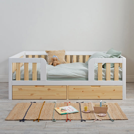 At what age should you move a toddler from a cot to a floor bed?