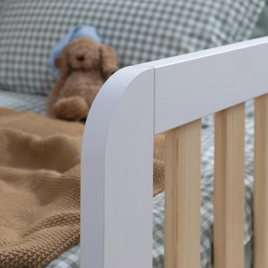 Should I choose a natural wood or white finish for a toddler bed?