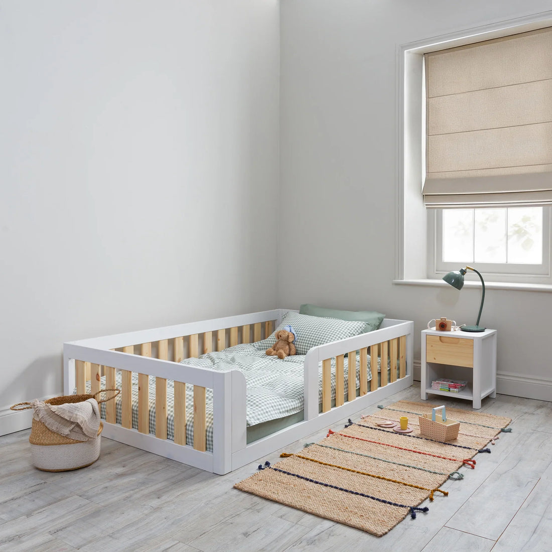 What is the difference between a floor bed and a standard toddler bed for a 2-year-old?