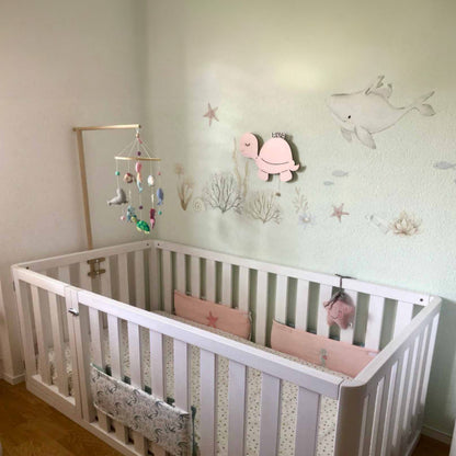 Four high sided toddler floor beds in a row, illustrating variety and customizable options for safe toddler sleeping