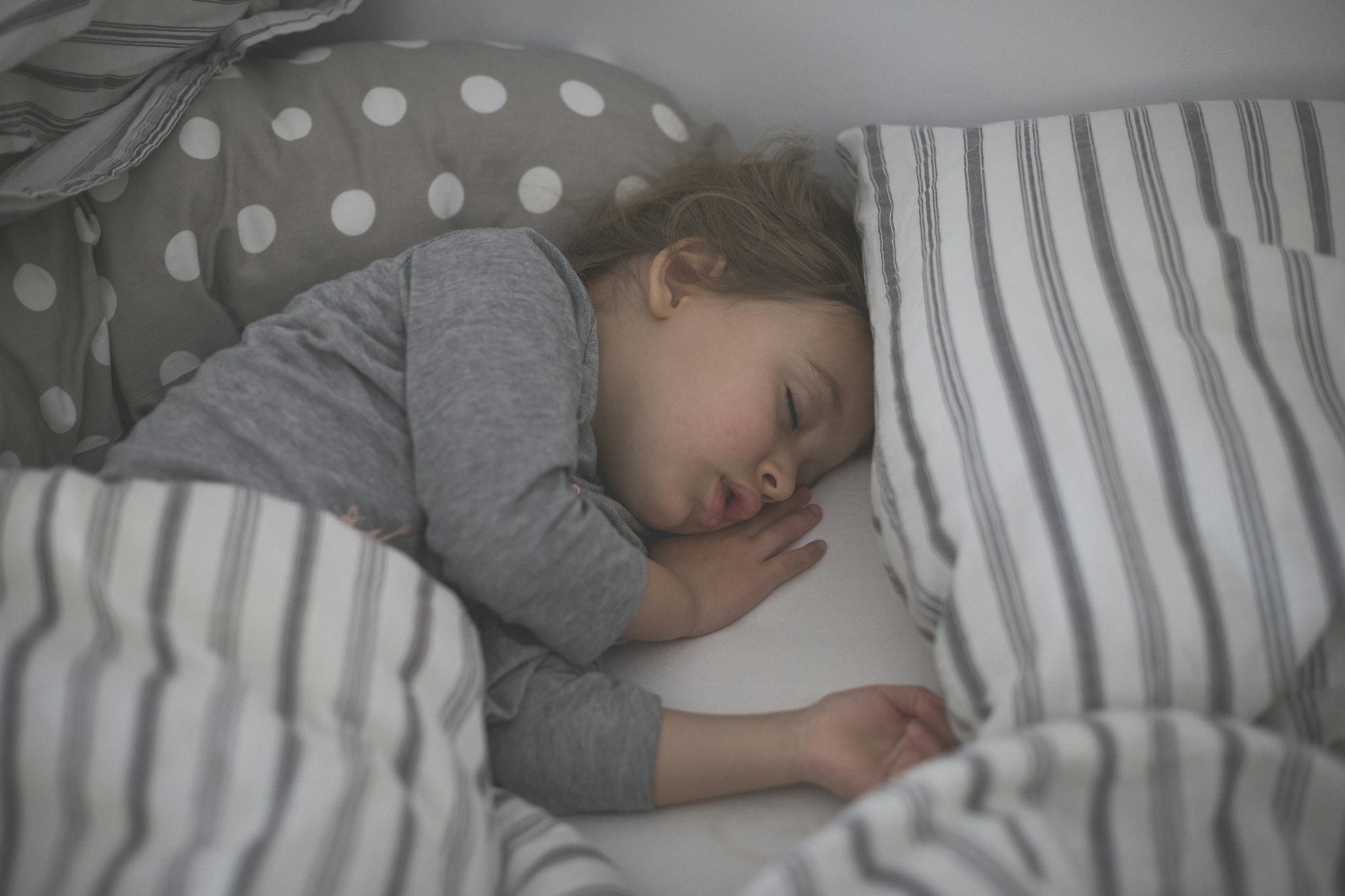 Toddler asleep in bed